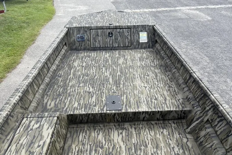 Slide: The Image of 2026 SeaArk DXS 1652 DKLD boat with camouflage pattern on a paved surface. - 14