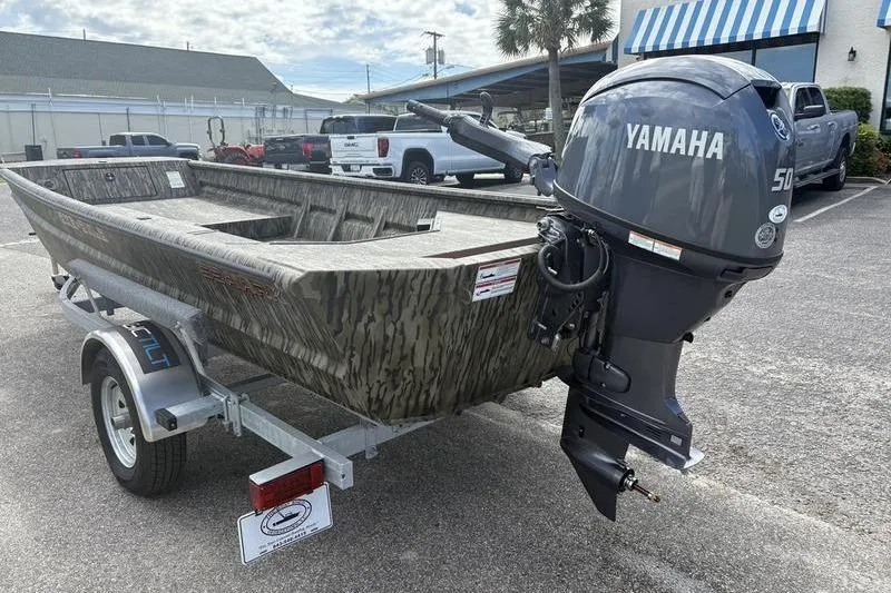 Slide: The Image of 2026 SeaArk DXS 1652 DKLD boat with Yamaha 50 engine on trailer. - 2