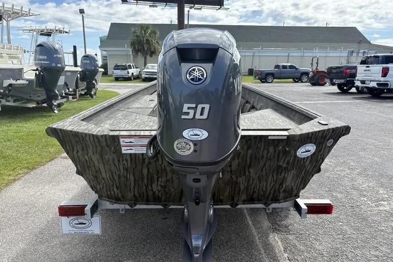 Slide: The Image of 2026 SeaArk DXS 1652 DKLD boat with Yamaha 50 engine, parked outdoors. - 3