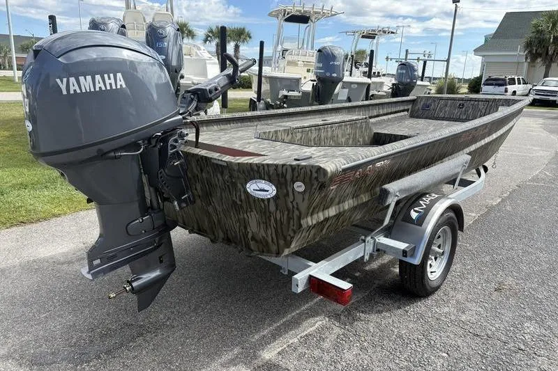 Slide: The Image of 2026 SeaArk DXS 1652 DKLD boat with Yamaha outboard motor on a trailer. - 4
