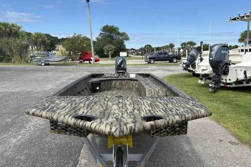 Slide: The Image of 2026 SeaArk DXS 1652 DKLD boat with camouflage design on a trailer. - 7