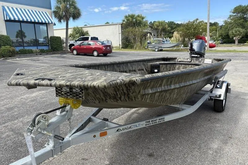 Slide: The Image of 2026 SeaArk DXS 1652 DKLD boat on trailer in parking lot. - 8