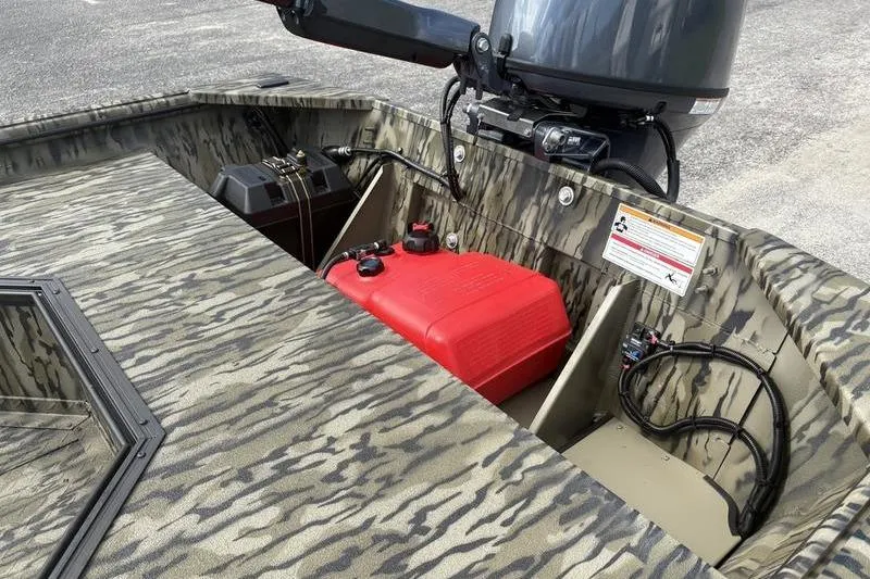 Slide: The Image of 2026 SeaArk DXS 1652 DKLD boat interior with camouflage design and motor. - 9