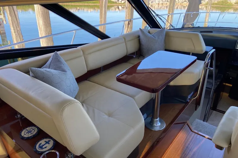 Slide: The Image of Luxurious interior of 2015 Sea Ray 470 Sundancer yacht with elegant seating and table. - 11