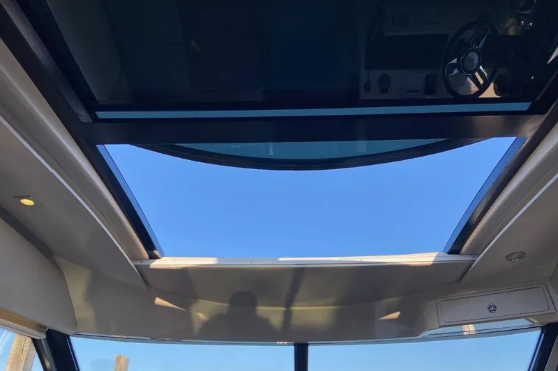 Slide: The Image of Interior view of 2015 Sea Ray 470 Sundancer yacht with open sunroof. - 13