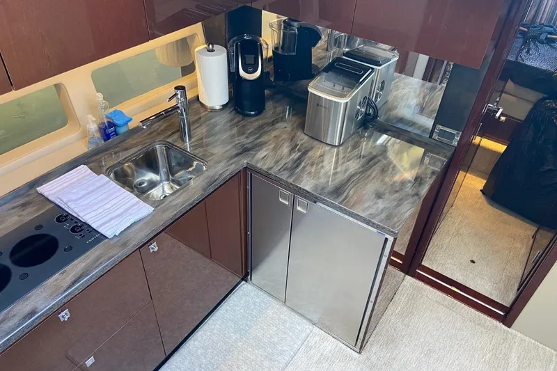 Slide: The Image of Luxurious kitchen area in 2015 Sea Ray 470 Sundancer yacht with modern appliances. - 15