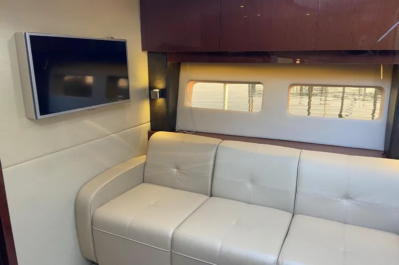 Slide: The Image of Luxurious interior of 2015 Sea Ray 470 Sundancer with leather sofa and mounted TV. - 17