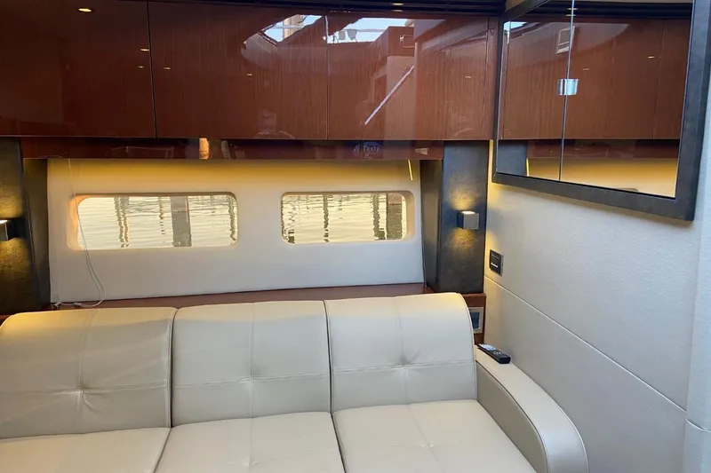 Slide: The Image of Luxurious interior of 2015 Sea Ray 470 Sundancer yacht with beige seating and wooden cabinets. - 18