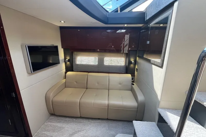 Slide: The Image of Luxurious interior of 2015 Sea Ray 470 Sundancer yacht with beige sofa and TV. - 19