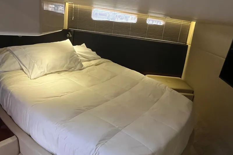 Slide: The Image of Luxurious bedroom interior of 2015 Sea Ray 470 Sundancer yacht with cozy bedding. - 25