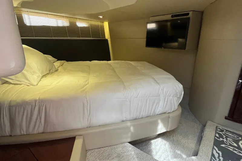 Slide: The Image of Luxurious bedroom interior of 2015 Sea Ray 470 Sundancer yacht with TV and cozy bedding. - 27