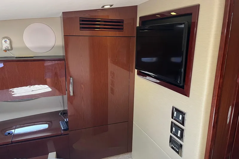 Slide: The Image of Luxurious interior of 2015 Sea Ray 470 Sundancer yacht with TV and wooden cabinetry. - 38