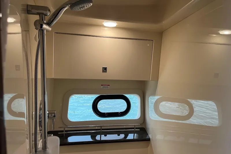 Slide: The Image of Interior of 2015 Sea Ray 470 Sundancer yacht bathroom with shower and window view. - 42
