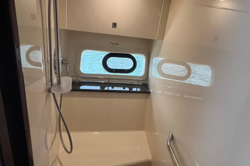 Slide: The Image of Interior of 2015 Sea Ray 470 Sundancer yacht bathroom with window and shower. - 43