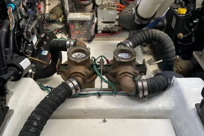 Slide: The Image of Engine room of 2015 Sea Ray 470 Sundancer with visible hoses and mechanical components. - 47
