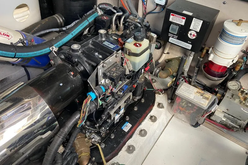 Slide: The Image of Engine room of a 2015 Sea Ray 470 Sundancer with visible wiring and components. - 48