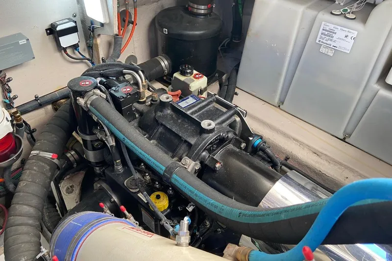 Slide: The Image of Engine compartment of 2015 Sea Ray 470 Sundancer, showcasing mechanical components and wiring. - 49