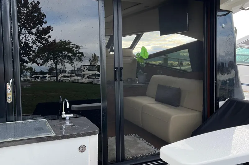 Slide: The Image of 2015 Sea Ray 470 Sundancer yacht interior with sofa and outdoor sink. - 54