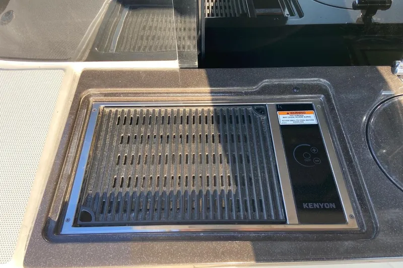 Slide: The Image of Outdoor grill on 2015 Sea Ray 470 Sundancer yacht, featuring Kenyon cooking surface. - 56