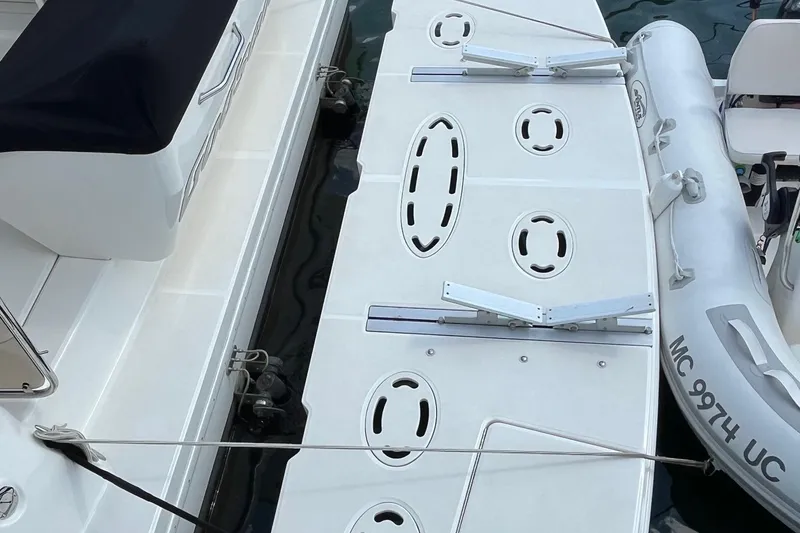 Slide: The Image of 2015 Sea Ray 470 Sundancer swim platform with attached inflatable boat. - 57