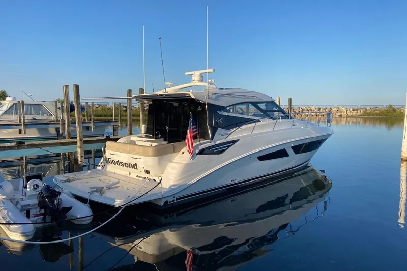 Slide: The Image of 2015 Sea Ray 470 Sundancer yacht docked in a serene marina setting. - 59