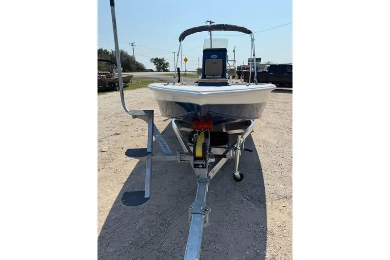 Slide: The Image of 2026 Avid 21 FSX boat on trailer, parked outdoors on gravel. - 2