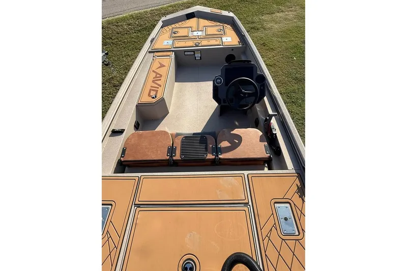 Slide: The Image of 2026 Avid 18 Rogue SC boat interior with tan seating and steering console. - 3