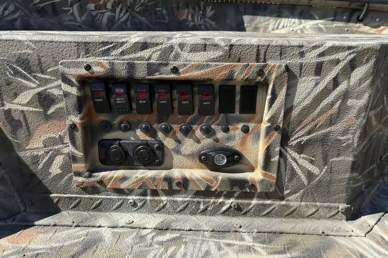 Slide: The Image of Control panel of 2026 SeaArk 1960 Slayer boat with camouflage design. - 10