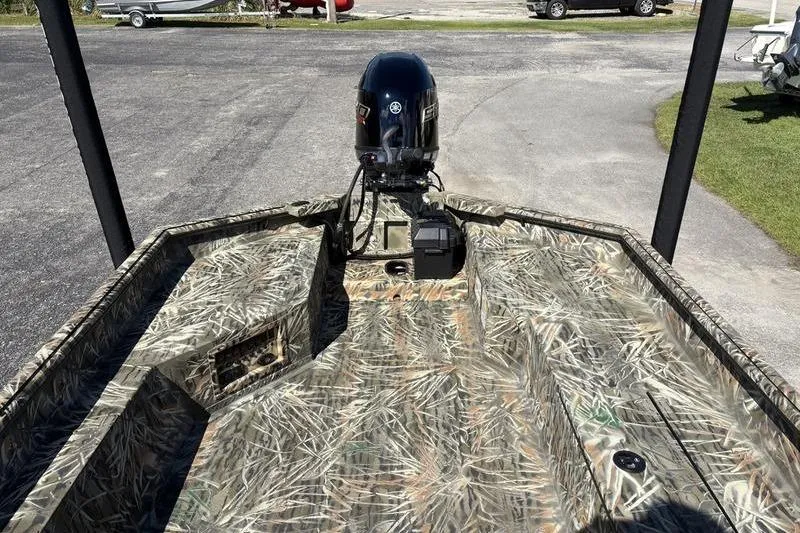 Slide: The Image of 2026 SeaArk 1960 Slayer boat with camouflage design and outboard motor. - 11