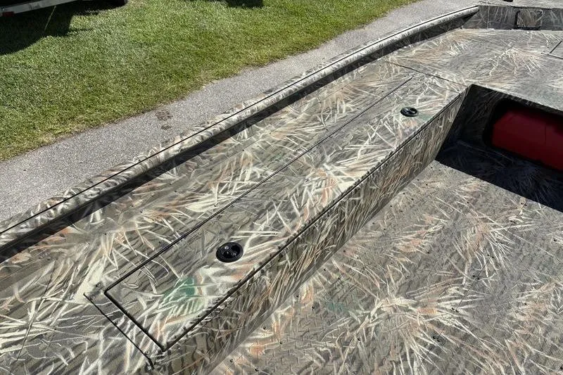 Slide: The Image of 2026 SeaArk 1960 Slayer boat with camouflage pattern, featuring storage compartments. - 12