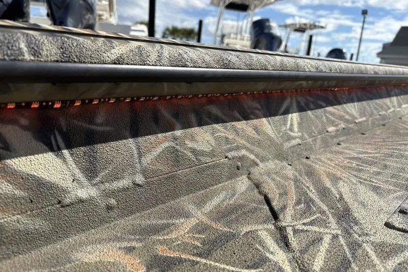 Slide: The Image of 2026 SeaArk 1960 Slayer boat with camouflage pattern and LED lighting detail. - 18