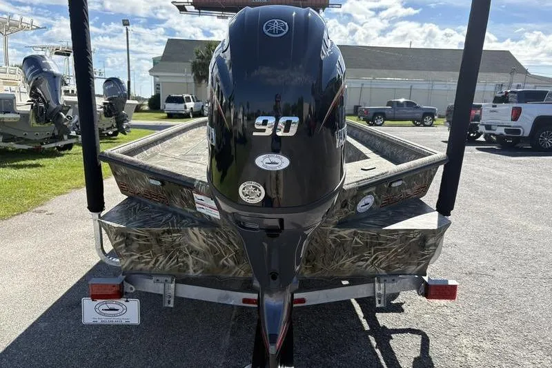 Slide: The Image of 2026 SeaArk 1960 Slayer boat with Yamaha 90 engine, parked outdoors. - 3