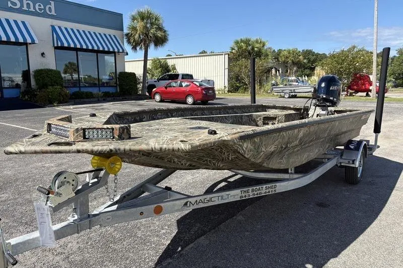 Slide: The Image of 2026 SeaArk 1960 Slayer boat on trailer, parked outside dealership. - 8