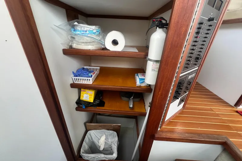 Slide: The Image of Storage shelves on a 1994 Zimmerman Marine Z36 Sedan Cruiser with cleaning supplies and fire extinguisher. - 8