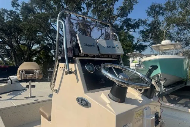 Slide: The Image of 2019 Xpress H20 boat dashboard with Garmin navigation system, steering wheel, and seating. - 15