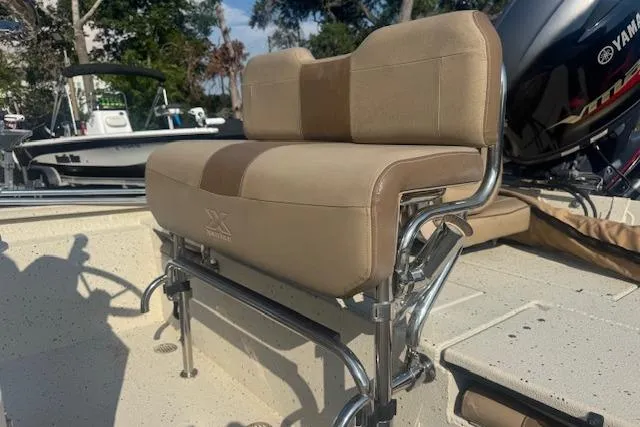 Slide: The Image of 2019 Xpress H20 boat with beige seating and Yamaha motor in a sunny outdoor setting. - 17