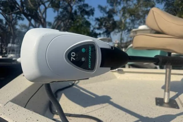 Slide: The Image of Trolling motor on 2019 Xpress H20 boat, outdoors with trees in background. - 18