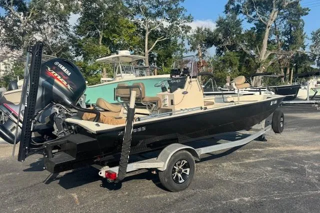 Slide: The Image of 2019 Xpress H20 boat with Yamaha engine on a trailer, parked outdoors. - 2