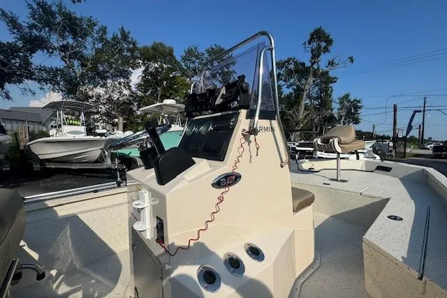 Slide: The Image of 2019 Xpress H20 boat console with steering wheel and controls, docked outdoors. - 20