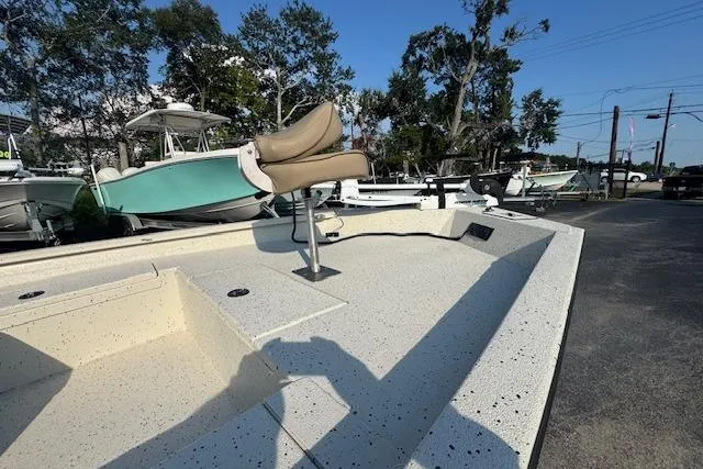 Slide: The Image of 2019 Xpress H20 boat with seating, parked outdoors under clear blue sky. - 22