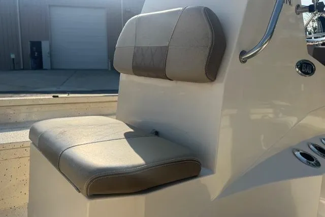 Slide: The Image of 2019 Xpress H20 boat seat with beige upholstery and backrest in sunlight. - 23