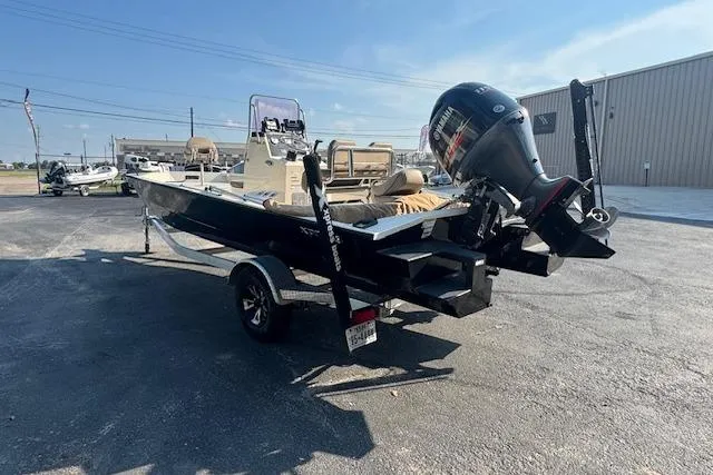 Slide: The Image of 2019 Xpress H20 boat with outboard motor on trailer in parking lot. - 3