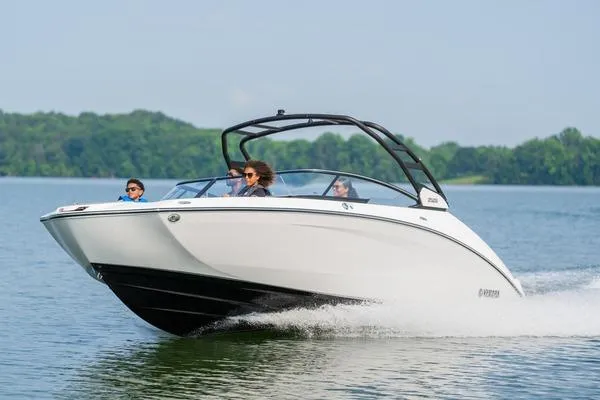The Image of 2026 Yamaha Boats 252S cruising on a lake with passengers, showcasing sleek design and performance. - 1