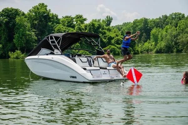 Slide: The Image of 2026 Yamaha Boats 252S on a lake with people enjoying water activities. - 10