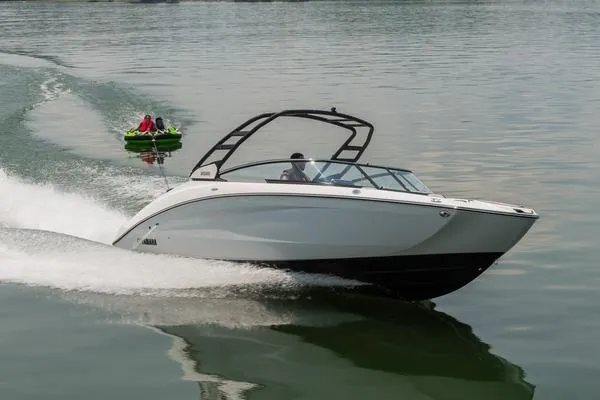 Slide: The Image of 2026 Yamaha Boats 252S speeding on water, towing a green inflatable tube. - 4