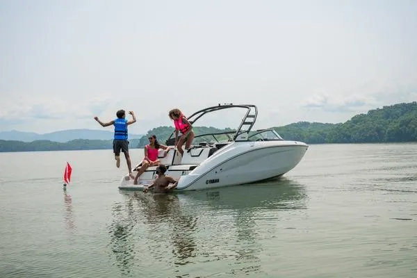 Slide: The Image of People enjoying a day on a 2026 Yamaha Boats 252S in a scenic lake. - 7