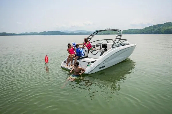 Slide: The Image of 2026 Yamaha Boats 252S with people enjoying water activities on a calm lake. - 9