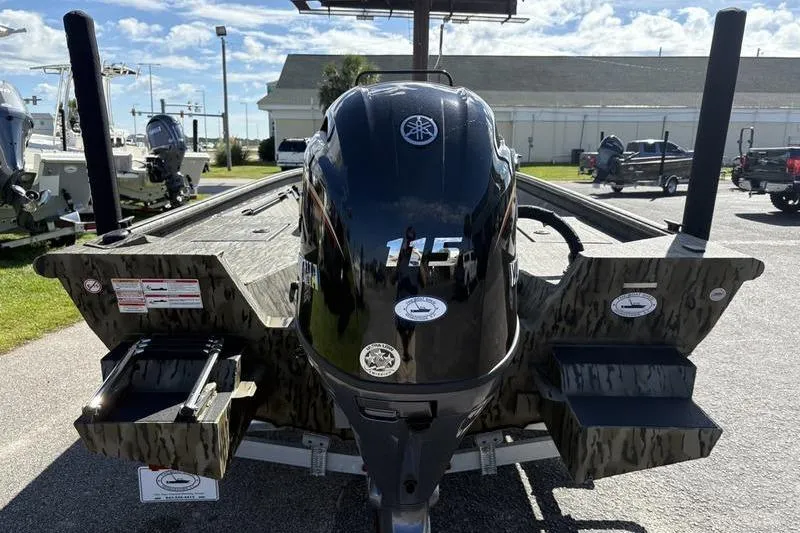 Slide: The Image of 2026 SeaArk Shadow 19 V Center Console with Yamaha 115 outboard engine, parked outdoors. - 16