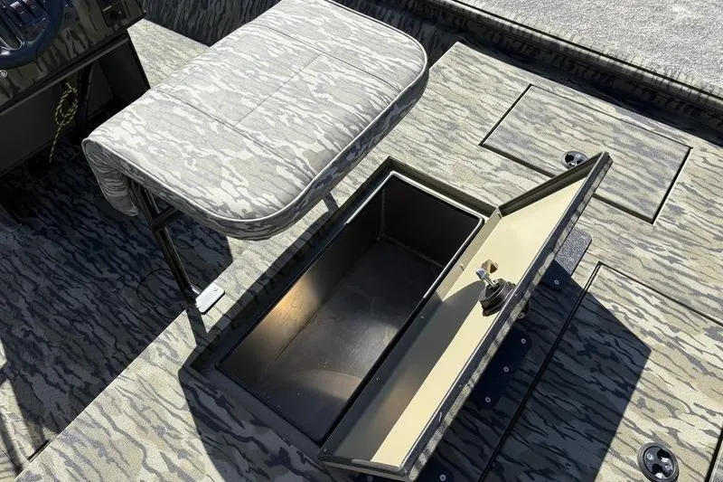 Slide: The Image of 2026 SeaArk Shadow 19 V Center Console with open storage compartment and camo seating. - 8