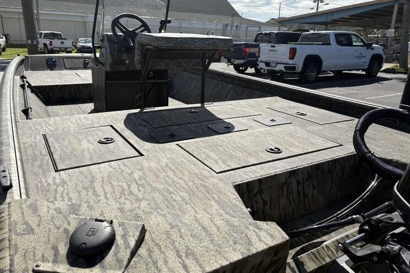 Slide: The Image of 2026 SeaArk Shadow 19 V Center Console boat with camo design in a parking lot. - 9